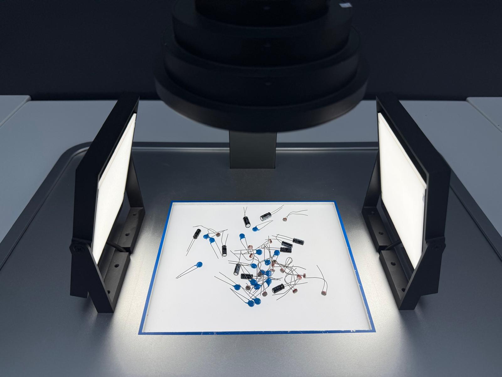 Overhead camera and light box inspecting mixed electronic components